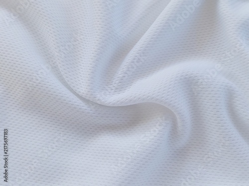 White football sportswear fabric close up with smooth jersey texture. Soft sports clothing textile background. Detailed white jersey fabric surface.