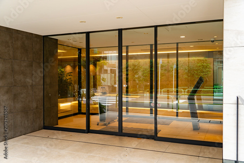 Modern apartment building entrance hall with glass doors