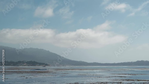 Mountains and ocean with clouds in sky