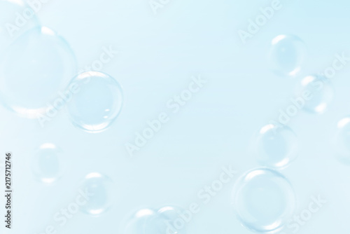 Clear Soap Bubbles Floating in The Air. Freshness Soap Suds Bubbles Water. Blue, Blue and White Gradient Blurred Background