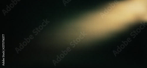 Abstract golden light streak glowing on a dark black background texture effect