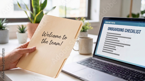 Welcome to the team note beside laptop showing onboarding checklist, representing new employee orientation and workplace integration