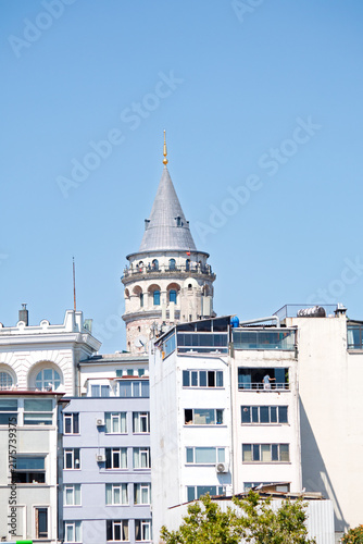 Galata Tower. The Galata Tower rising behind the buildings. Historic architectural structure. Istanbul's popular tourism destination. Cultural tour, travel. 