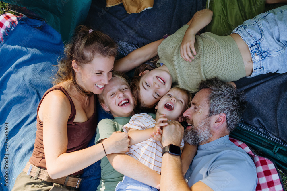 Naklejka premium Happy family spending time together during summer camping trip.