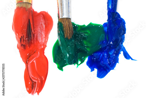 Different colors of paint on brushes with red, green, and blue hues