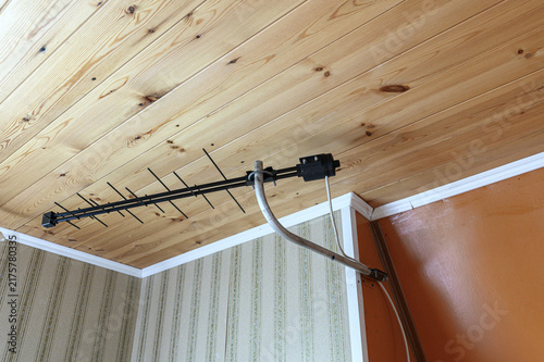 Obraz na plátně black TV antenna is mounted on light‑wood ceiling