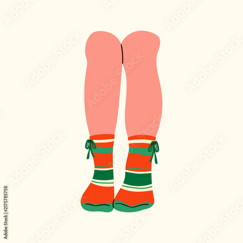 Cozy feet in warm woolen socks relaxing by a fireplace. Winter home comfort, hygge lifestyle, and seasonal relaxation concept. Soft knitted texture, warm aesthetic, and comfortable indoor mood.