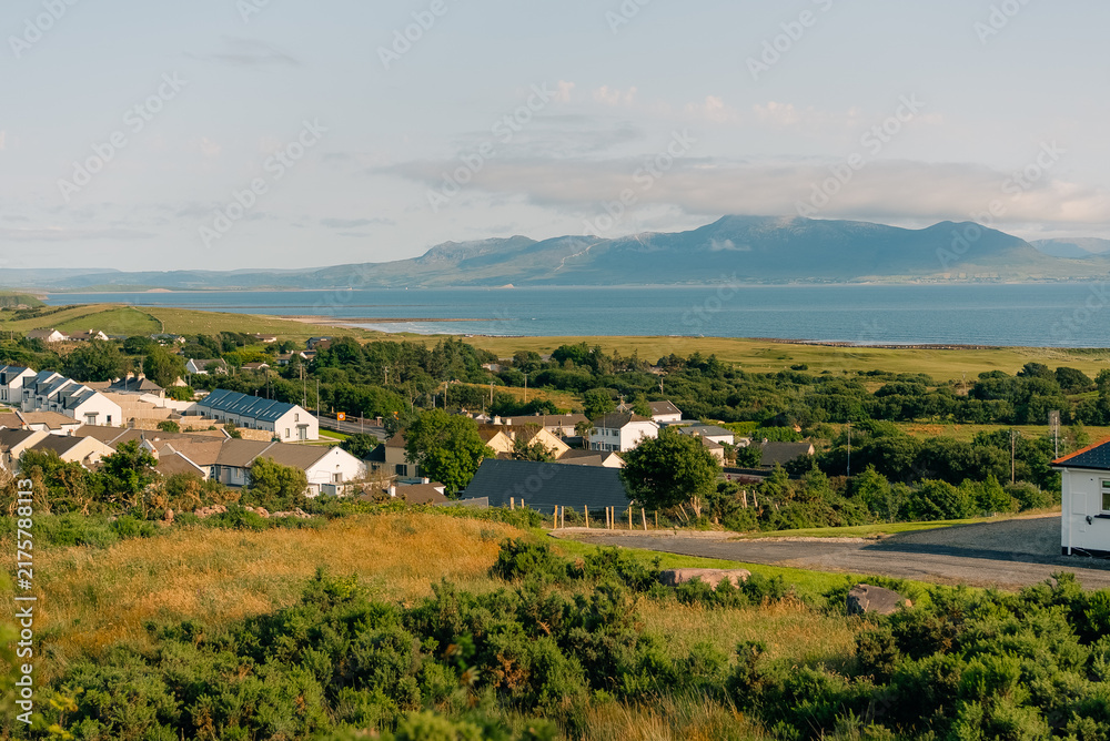 Fototapeta premium Scenic view of Clew Bay and the coastal village of Murrisk, surrounded by green hills and mountains along Ireland Wild Atlantic Way - County Mayo, Ireland - 31 August 2026.