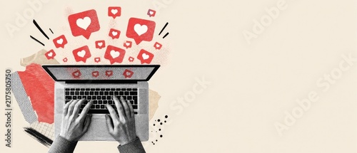 Overhead view of person typing on laptop with heart like icons emerging, symbolizing social media engagement and online popularity.