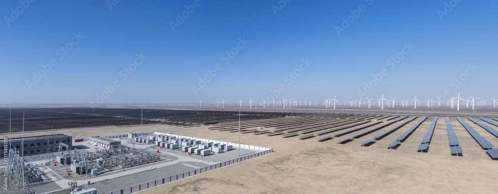 Naklejka premium Vast Solar And Wind Power Plant With Substation In Desert