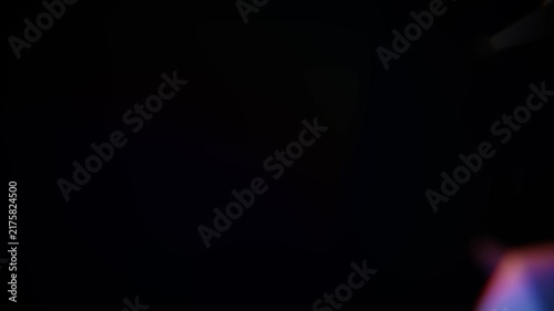 Abstract background showing dispersion and reflection of light through glass facets creating a flare. Seamless loop