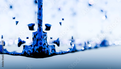 Blue water splash with droplets captured in close-up