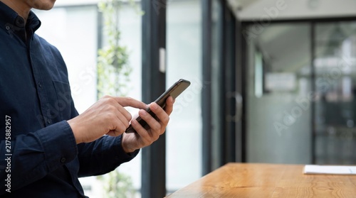 Businessman using a smartphone in a modern office setting