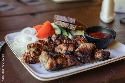 Grilled Pork Pieces With Fresh Vegetables, Bread and Sauce