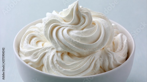 Whipped cream swirl in white bowl