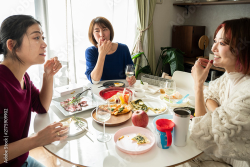 Group of Asian Women Friends Talking and Enjoying Home Party at Dining Table