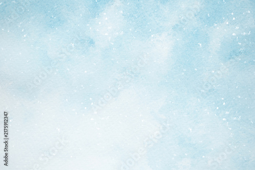 A blue watercolor background with falling snow for designing winter holiday web banners