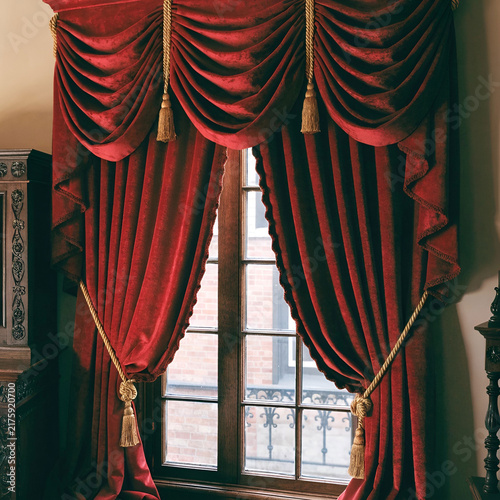 luxury red curtains in Victorian style with drape