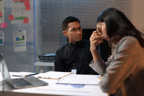 Quadro su tela Employee feeling stressed and anxious during a reprimand from her boss late at night, dealing with workplace conflict and pressure