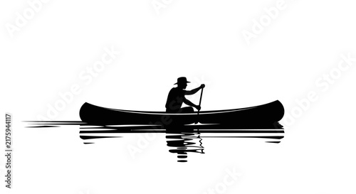 Silhouette of a person in a canoe on calm water, with reflection