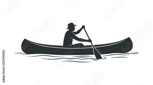 Silhouette of a person in a canoe rowing on water