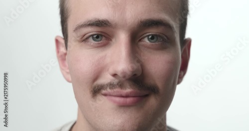 Extreme Close-up of Young Man Smiling at Camera on White Background