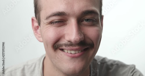 Extreme Close-up of Young Man Smiling directly at Camera on White Background