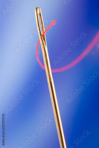 Close Up Of Needle And Red Thread