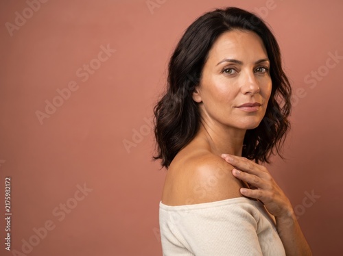 Beautiful Young Woman with clean, fresh skin. Facial treatment. Cosmetology, beauty, and spa. A nice and attractive girl with a pleasant smile.	