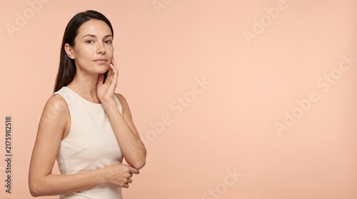 Beautiful Young Woman with clean, fresh skin. Facial treatment. Cosmetology, beauty, and spa. A nice and attractive girl with a pleasant smile.	