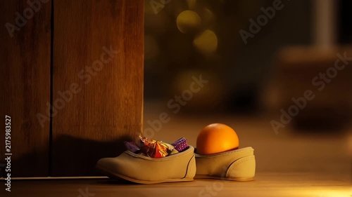 Saint Nicholas Day Tradition with Childrens Shoes Filled with Candies and Orange