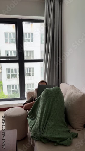 Person working from home on a laptop at a desk in a comfortable home environment. Remote work, home office, productivity and modern lifestyle concept.