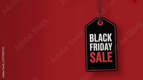 Black friday sale tag hanging against a solid red background for retail marketing and shopping promotion