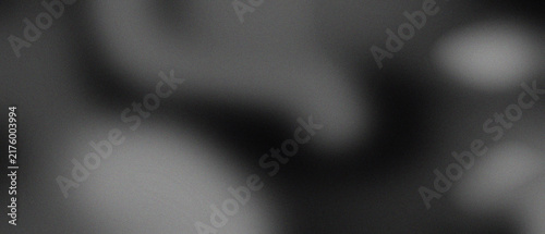 Foto Abstract dark grey grainy background with soft blurred light spots