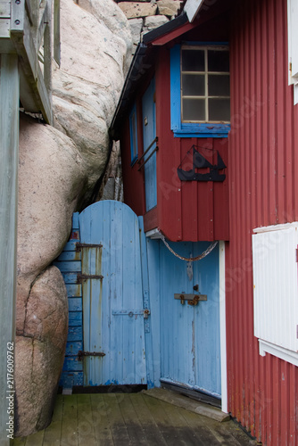 Charming Blue Wooden Door Built Right Against Granite Rock in Smogen
