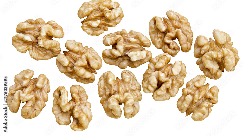 Fototapeta premium Scattered raw walnut halves natural texture, isolated on transparent background