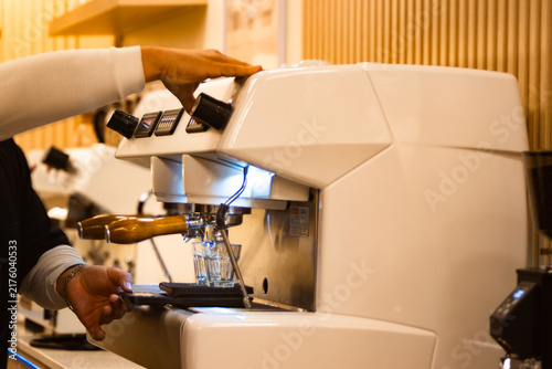 Photography A barista prepares espresso on a modern coffee machine