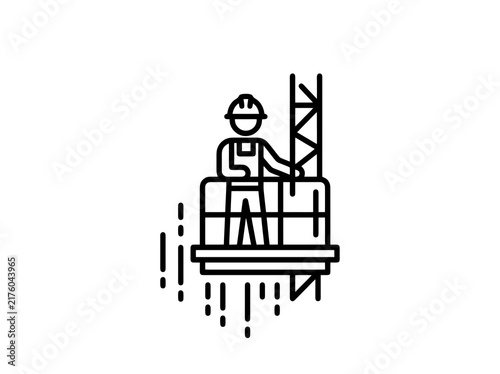 Construction worker on a platform with scaffolding while working at height in a city setting