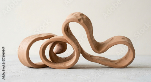 Modern Abstract Handmade Clay Sculpture with Fluid Organic Curves on Neutral Background