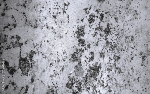 Obraz na płótnie Monochrome aged concrete surface with scattered dark patches, rough texture and natural weathering, useful as a grunge background, industrial backdrop or texture overlay