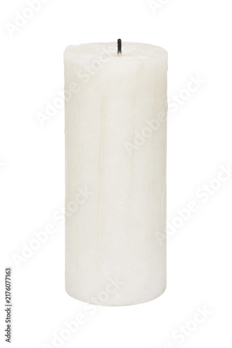 Konstfotografi Single white pillar candle with a burnt wick stands upright, showing melted wax