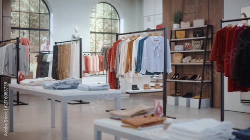 Clothing Store Shopping: Interior Designed in a Contemporary Boutique Style, With Organized Garment Racks, Mannequin Presentations, Accessory Shelving and Refined Visual Merchandising in Spacious Shop