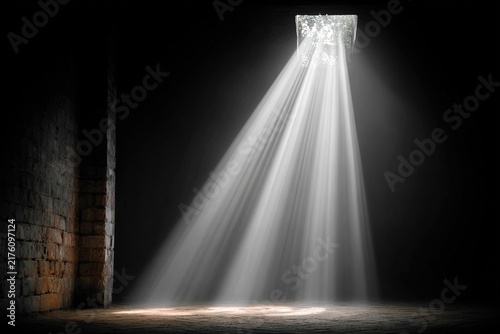 Spotlight on a dark brick wall, concept of hope and revelation