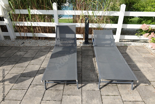 Cuadro en lienzo Outdoor sun loungers in a relaxing leisure area