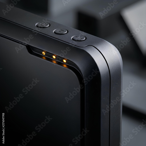 Black electronic device with LED indicators and buttons close up