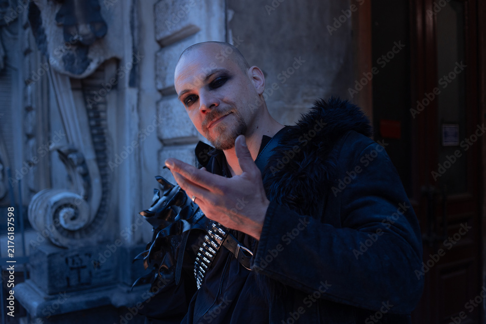 Fototapeta premium Dark magician making a hand gesture, spell and magic concept in gothic male style.