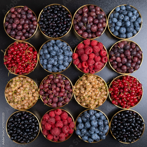Vertical Diagonal Arrangement Of Fresh Berry Bowls From Above. Blueberries Raspberries And Currants In A Dynamic Offset Layout