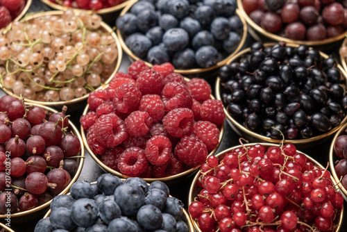 Close Angled Shot Of Fresh Mixed Berries In Small Bowls