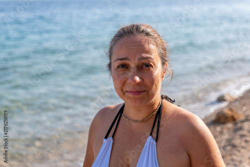 фотографія Smiling woman portrait on a sunny Croatian beach by the sea