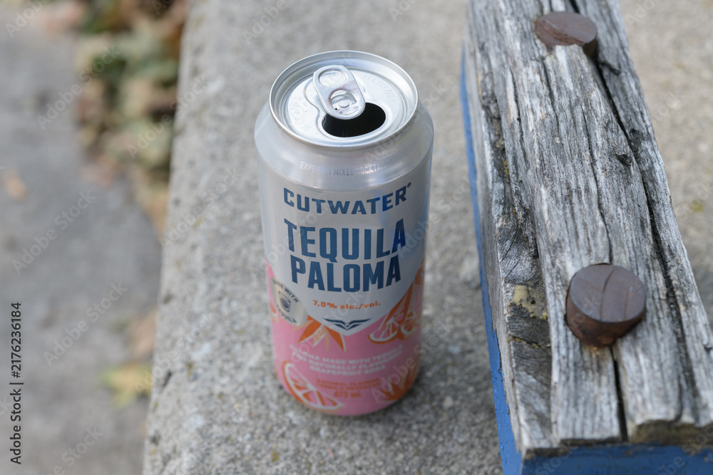 Obraz premium discarded 355 mL RTD cocktail Anheuser-Busch Cutwater Tequila Paloma on a short wall next to cinder block wood cap, Toronto